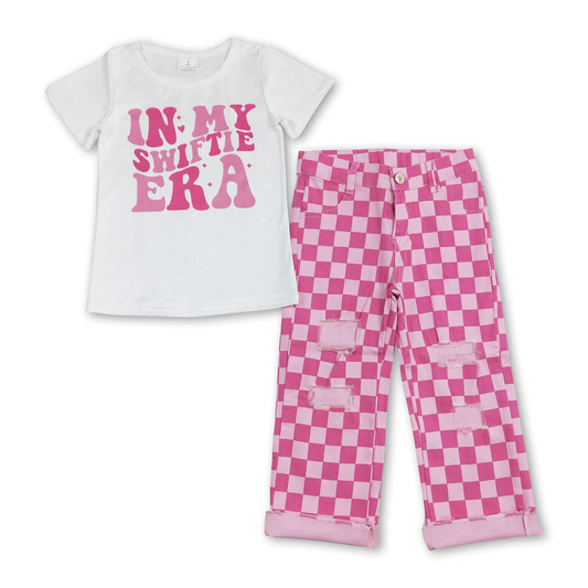 swiftie tee and pink checkered denim pants outfit