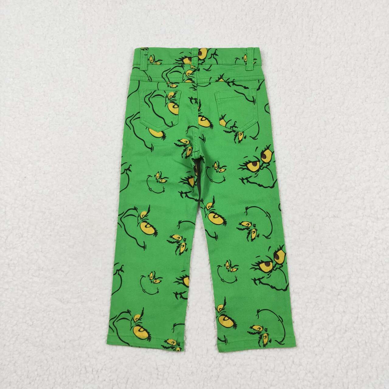 green grinchey print denim jeans