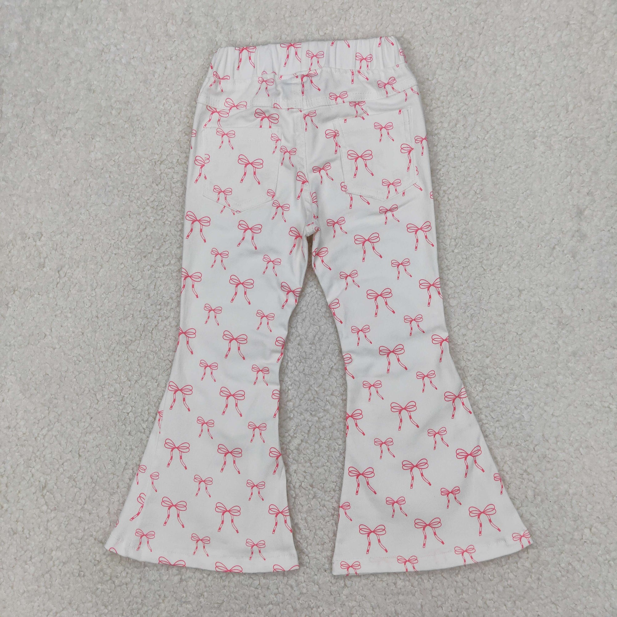pink bow on white girl jeans